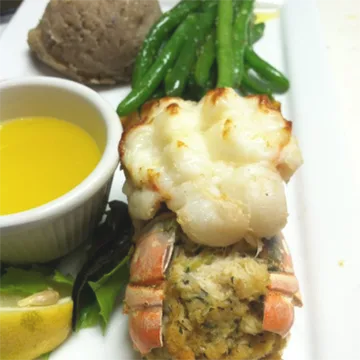 Stuffed lobster tail with green beans and drawn butter