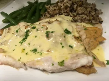 Fish fillet in lemon butter sauce with green beans and rice pilaf