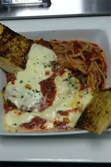 Chicken parmesan with marinara and melted mozzarella, spaghetti, and garlic bread