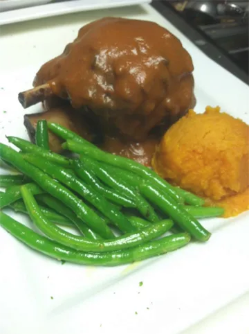 Braised lamb shank with green beans and sweet potato mash